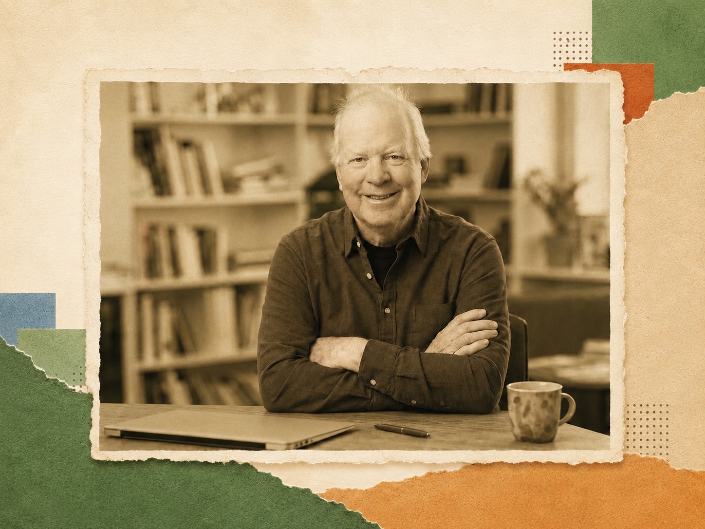Patrick Curry smiling at his desk, arms crossed, bookshelves behind him
